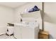 Functional laundry room equipped with modern appliances and storage space for convenience at 2312 Dogwood Dr, Erie, CO 80516