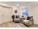 Inviting sitting area with wood flooring, comfortable seating and stylish decor at 2312 Dogwood Dr, Erie, CO 80516