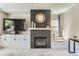 Charming living room featuring a fireplace, a large TV, and a built-in window seat at 2312 Dogwood Dr, Erie, CO 80516