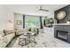 Cozy living room with fireplace and backyard views through a large picture window at 2312 Dogwood Dr, Erie, CO 80516