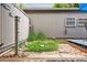Charming backyard features a small garden area with decorative stone and fencing at 6515 Pinewood Dr, Parker, CO 80134