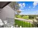 Balcony view featuring golf course, blue skies, and a charming seating area at 6515 Pinewood Dr, Parker, CO 80134