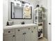 Updated bathroom with a large mirror, storage shelves, and a modern vanity at 6515 Pinewood Dr, Parker, CO 80134