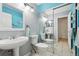 Compact bathroom with double sinks, tile floors, and mirrored closet doors at 6515 Pinewood Dr, Parker, CO 80134