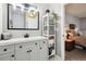 Renovated bathroom featuring white cabinets, quartz countertops, and stylish fixtures at 6515 Pinewood Dr, Parker, CO 80134
