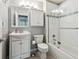 Renovated bathroom showcasing a vanity, toilet, and shower-tub combo with a glass door and modern fixtures at 6515 Pinewood Dr, Parker, CO 80134