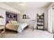 Cozy bedroom featuring soft carpet, stylish decor, and a comfortable rocking chair at 6515 Pinewood Dr, Parker, CO 80134
