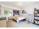 Comfortable bedroom with stylish decor, featuring a lavender accent wall and cozy rocking chair at 6515 Pinewood Dr, Parker, CO 80134