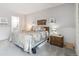 Inviting bedroom featuring a queen bed, soft carpet and decor shelves at 6515 Pinewood Dr, Parker, CO 80134