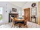 Dining area with round table, natural light, wooden furnishings, and vaulted ceilings at 6515 Pinewood Dr, Parker, CO 80134