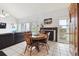 Dining area with round table, natural light, and adjacent living area with black fireplace at 6515 Pinewood Dr, Parker, CO 80134
