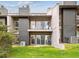 Multi-level townhouse featuring a grassy lawn, private balconies, and outdoor seating at 6515 Pinewood Dr, Parker, CO 80134