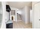 Inviting foyer featuring tiled flooring, coat rack, and convenient access to the upper and lower levels at 6515 Pinewood Dr, Parker, CO 80134