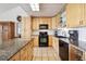 Bright kitchen with stainless steel appliances, tile backsplash, and granite countertops at 6515 Pinewood Dr, Parker, CO 80134