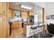 Bright kitchen with stainless steel appliances, granite island, and adjacent breakfast bar with seating at 6515 Pinewood Dr, Parker, CO 80134