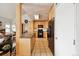 Kitchen featuring tile floors, ample cabinets, and black appliances next to the living area at 6515 Pinewood Dr, Parker, CO 80134