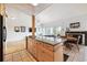 Open kitchen with granite island, flowing into living area with fireplace and plenty of natural light at 6515 Pinewood Dr, Parker, CO 80134