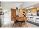 Bright kitchen with granite island flowing into dining area with wooden furnishings and bright lighting at 6515 Pinewood Dr, Parker, CO 80134