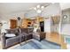 Open-concept living area with a comfortable sofa, kitchen access, and bright natural light at 6515 Pinewood Dr, Parker, CO 80134