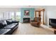 Cozy living room with a fireplace, comfortable seating, and a view of the outdoor golf course at 6515 Pinewood Dr, Parker, CO 80134