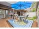 Inviting outdoor patio with seating, a blue umbrella, and decorative elements at 6515 Pinewood Dr, Parker, CO 80134