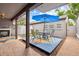Inviting outdoor patio with seating, a blue umbrella, and decorative elements at 6515 Pinewood Dr, Parker, CO 80134