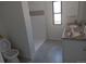 Bright bathroom featuring double sinks and a tiled shower at 102 Jackson Dr, Firestone, CO 80520