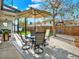 Relaxing backyard patio with an umbrella table, chairs, and a peaceful outdoor setting at 13935 E Idaho Pl, Aurora, CO 80012