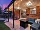 Inviting backyard patio featuring cozy seating, outdoor lighting, and a seamless transition to indoor living at 13935 E Idaho Pl, Aurora, CO 80012