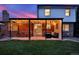 Covered backyard patio featuring stylish lighting, brick accents, and cozy seating for outdoor enjoyment at 13935 E Idaho Pl, Aurora, CO 80012