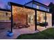 Charming backyard patio with string lights, comfortable seating, and a cozy fire pit at 13935 E Idaho Pl, Aurora, CO 80012