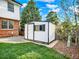 Backyard featuring a shed for storage with a grass lawn, and partial tree shading at 13935 E Idaho Pl, Aurora, CO 80012