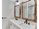 This bright bathroom features double sinks with rustic wood-framed mirrors at 13935 E Idaho Pl, Aurora, CO 80012