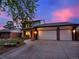 Charming two-story home featuring brick accents, manicured front yard, and a three-car garage at 13935 E Idaho Pl, Aurora, CO 80012