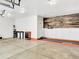 Spacious garage with ample storage and a well-organized workspace and decorative wall features at 13935 E Idaho Pl, Aurora, CO 80012