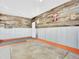 Finished garage features a wood accent wall and metal wainscotting with orange trim at 13935 E Idaho Pl, Aurora, CO 80012
