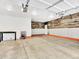 Finished garage space featuring insulated garage door, workbench, and wood accent wall at 13935 E Idaho Pl, Aurora, CO 80012