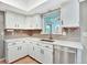 Updated kitchen with quartz countertops, white cabinets, and a stainless steel dishwasher at 13935 E Idaho Pl, Aurora, CO 80012