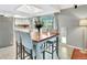 Eat-in kitchen featuring a square wooden table with chairs, modern appliances and beautiful sunlight at 13935 E Idaho Pl, Aurora, CO 80012