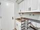 Functional laundry room with white cabinets, utility sink, and plenty of storage space at 13935 E Idaho Pl, Aurora, CO 80012