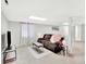 Relaxing living room features a large couch, TV, and soft lighting at 13935 E Idaho Pl, Aurora, CO 80012
