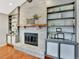 Close-up of a fireplace with built-in shelves in a living room with hardwood floors at 13935 E Idaho Pl, Aurora, CO 80012