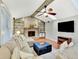 Bright living room showcasing a fireplace, built-in shelves, a comfortable sectional couch, and hardwood floors at 13935 E Idaho Pl, Aurora, CO 80012