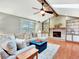 Bright living room showcasing a fireplace, built-in shelves, a comfortable sectional couch, and hardwood floors at 13935 E Idaho Pl, Aurora, CO 80012