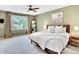 Spacious bedroom features a ceiling fan, large window, and cozy decor at 13935 E Idaho Pl, Aurora, CO 80012