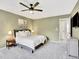 This spacious main bedroom features an elegant ceiling fan and calm light green walls at 13935 E Idaho Pl, Aurora, CO 80012