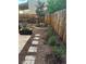 Cozy backyard retreat with pavers, mulch, and well-placed plants along the fence at 279 Delaware St, Denver, CO 80223