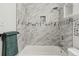 Elegant marble tiled shower featuring integrated shelf and a shower head at 279 Delaware St, Denver, CO 80223