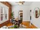 Cozy dining room with exposed brick wall and view into the kitchen at 279 Delaware St, Denver, CO 80223