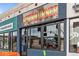 Modern restaurant with a vibrant storefront, featuring large windows and colorful signage for calzones at 279 Delaware St, Denver, CO 80223
